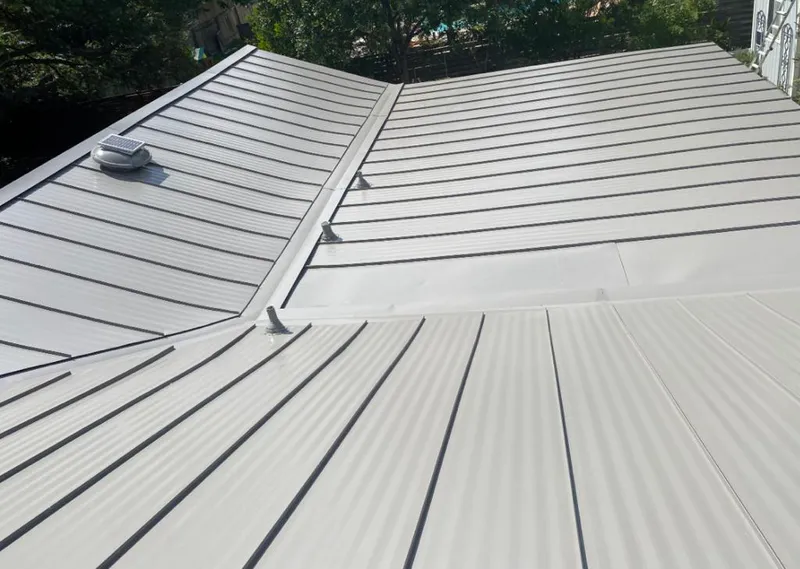 Solar attic fan installed on a metal roof for Roof Ventilation in Doolittle
